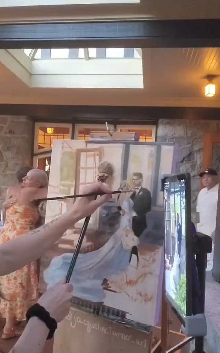 Jacqueline painting a couple's first dance live at their wedding