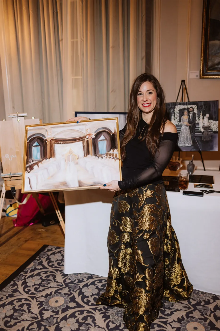 Jacqueline Turner holding the finished La Marie runway painting