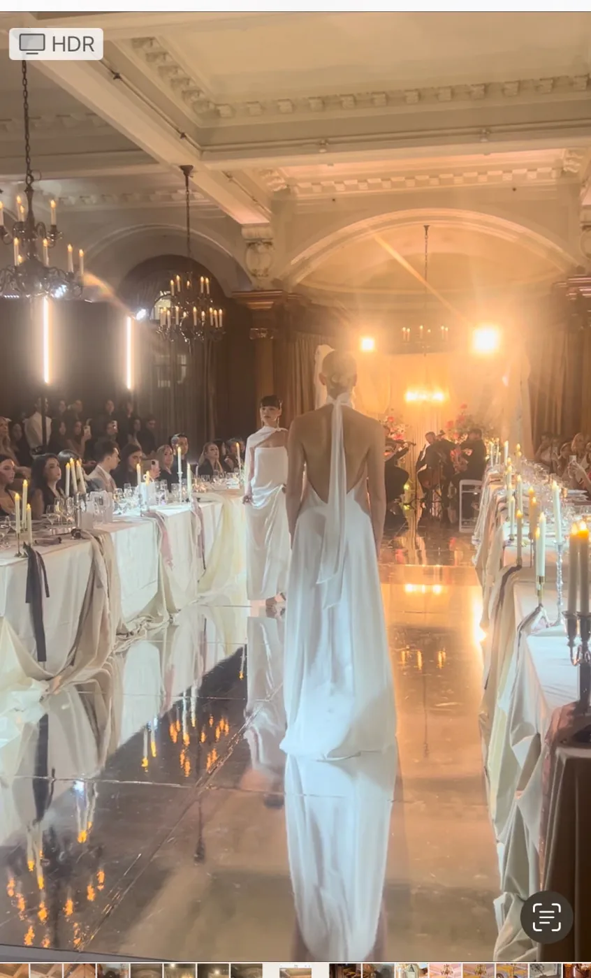 Bridal models walking the candlelit runway between dinner tables at The Vancouver Club