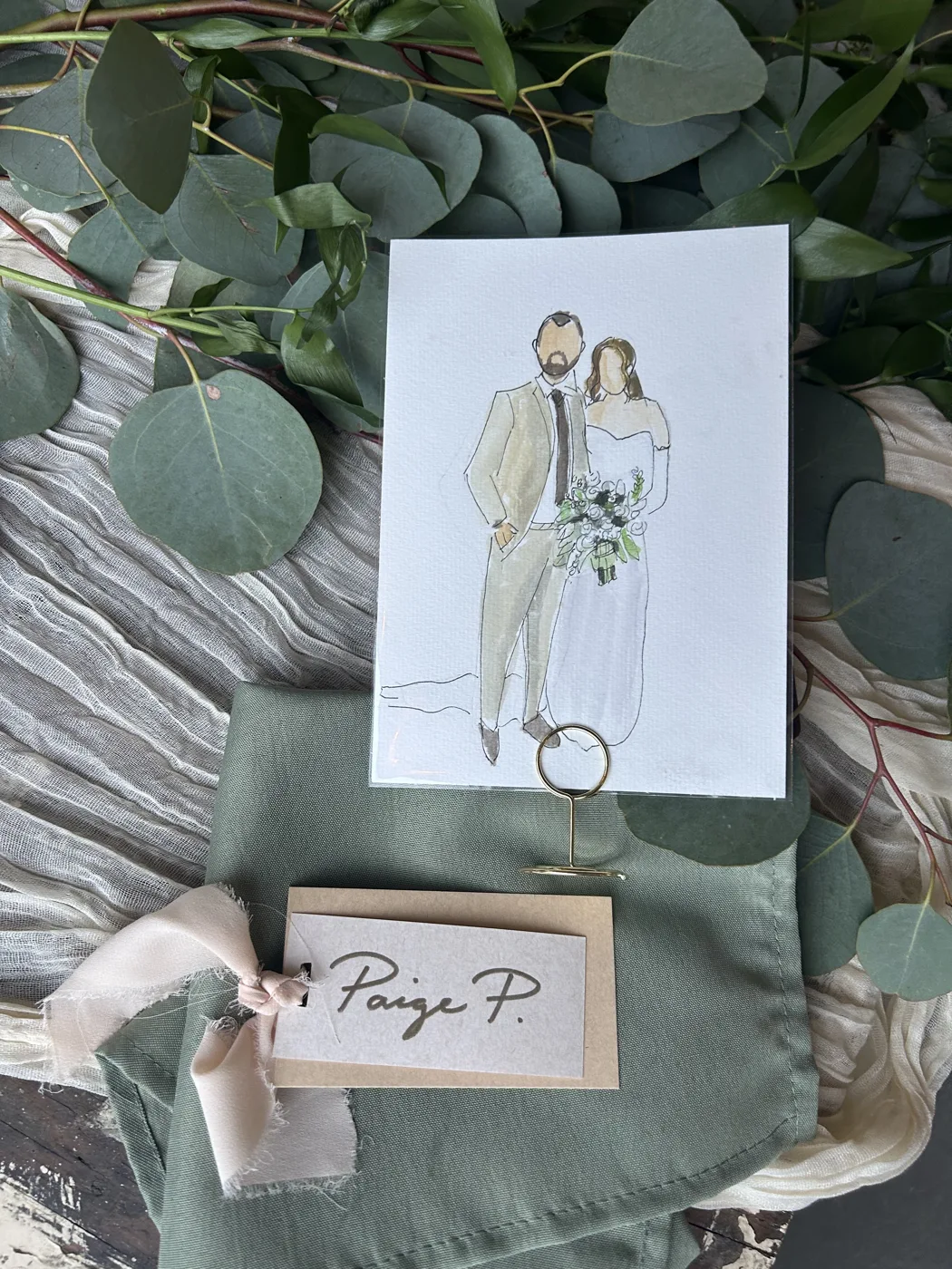Watercolour illustration of the bride and groom beside their handwritten place card