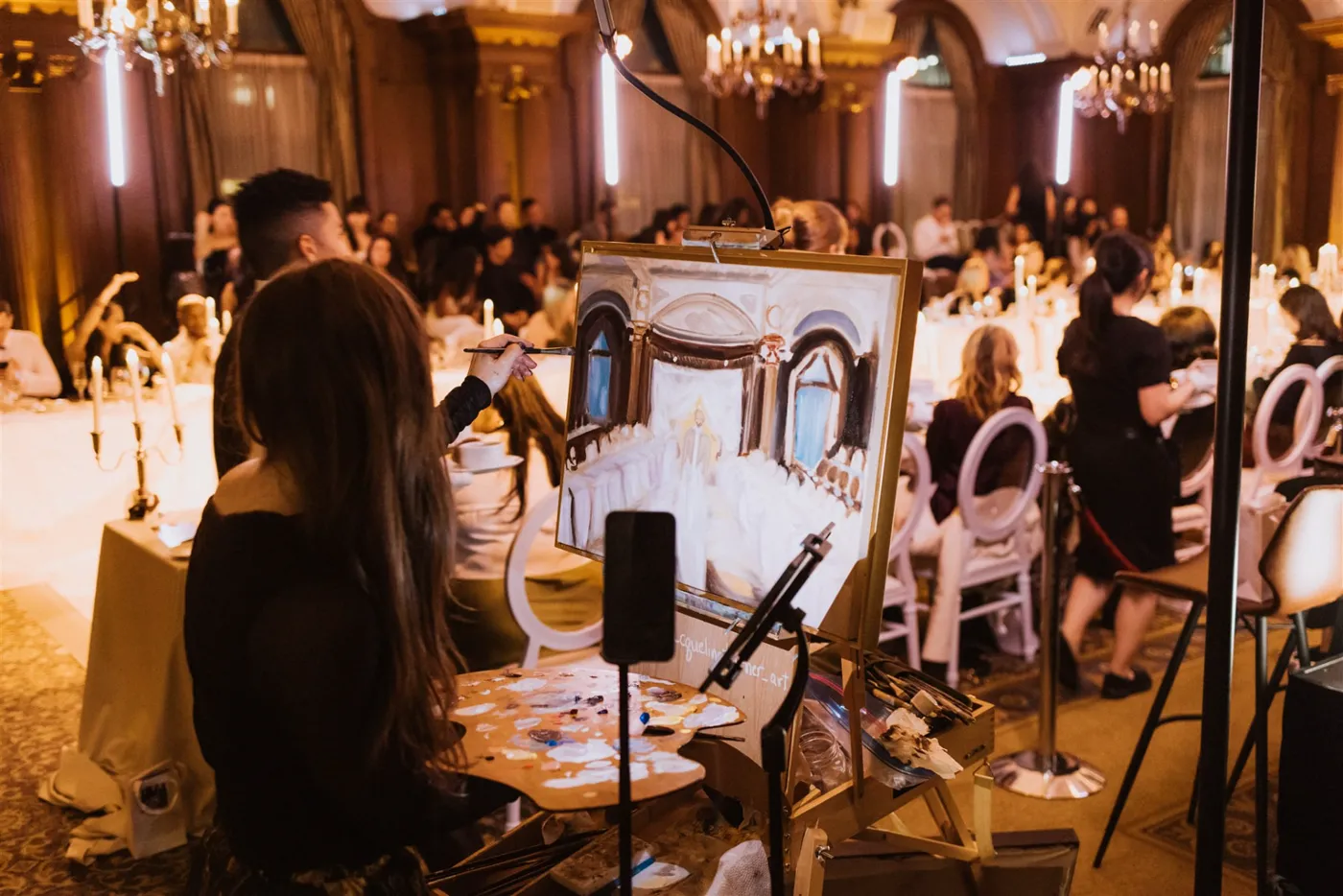 Painting live beside the dinner tables during the fashion show at The Vancouver Club