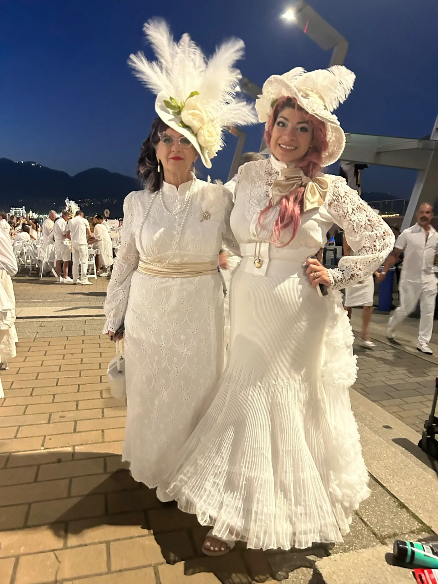 Guests in elegant white outfits at Dinner en Blanc Vancouver