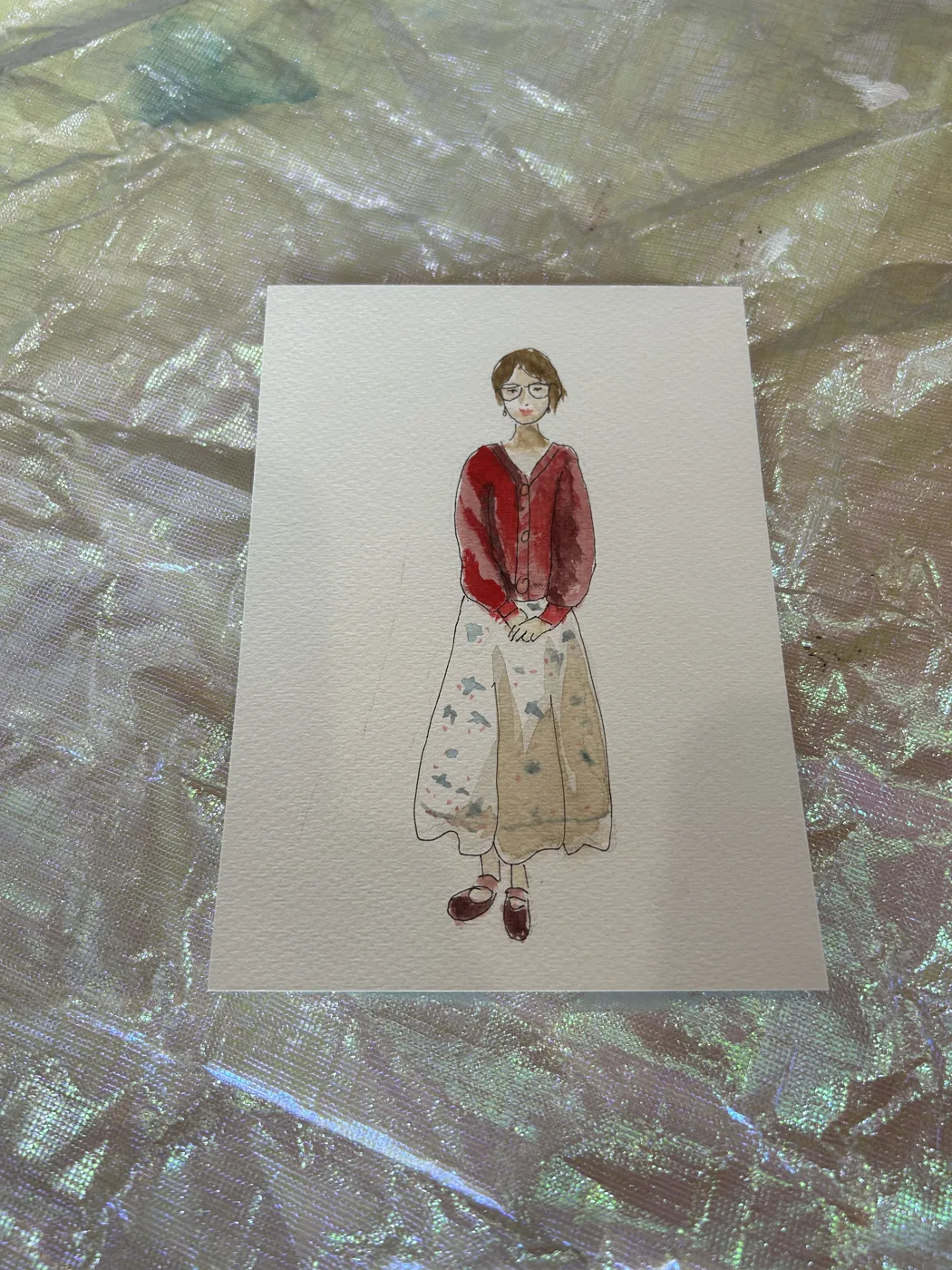 Watercolour illustration of a guest in a red sweater and floral skirt